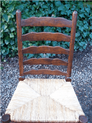 A Set of 7 Oak Ladder Back Chairs