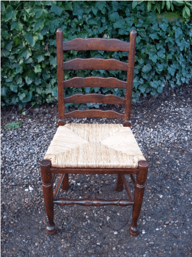 A Set of 7 Oak Ladder Back Chairs