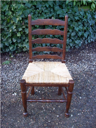 A Set of 7 Oak Ladder Back Chairs