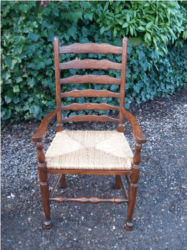 A Set of 7 Oak Ladder Back Chairs
