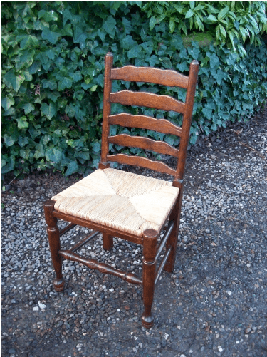A Set of 7 Oak Ladder Back Chairs