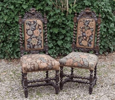 A Pair of Carved Oak Hall Chairs