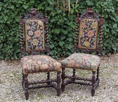 A Pair of Carved Oak Hall Chairs